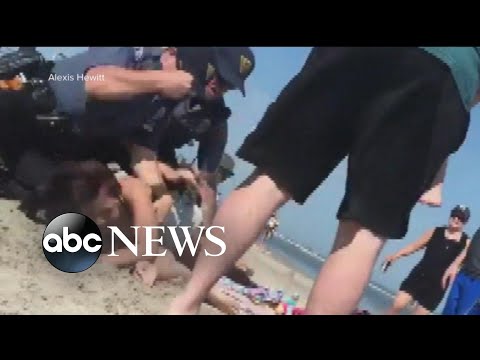 Policeman punches young woman in the head on the Jersey Shore