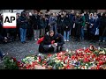 People in Prague pay their respects to victims of university shooting