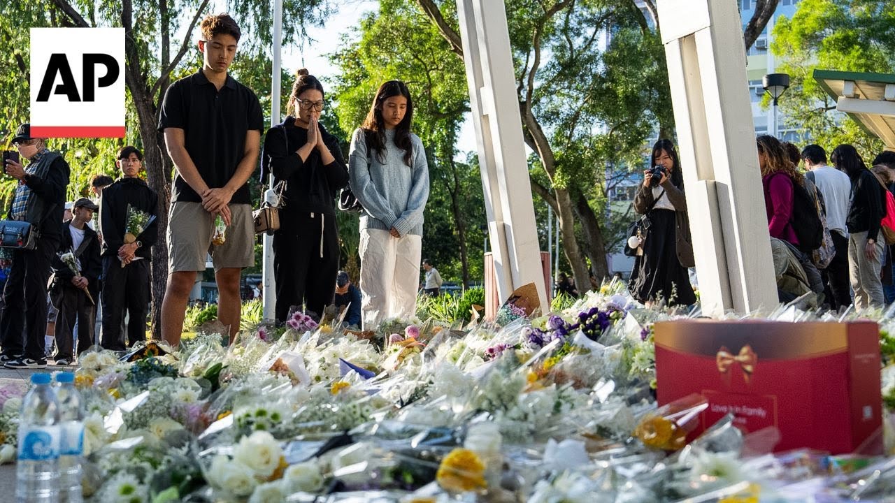 Flowers laid in tribute to those killed in massive Hong Kong fire