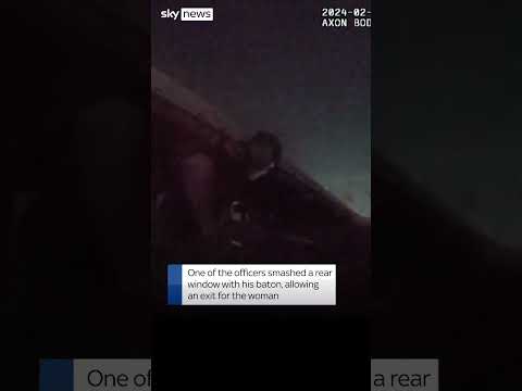 Police officers rescue a woman who was trapped in a car that had been driven off a bridge in Texas