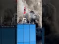 Man rescued from roof of burning high-rise by crane - ABC News