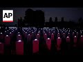 Tombstones of fallen WWII soldiers lit up at Normandy cemetery for D-Day commemorations