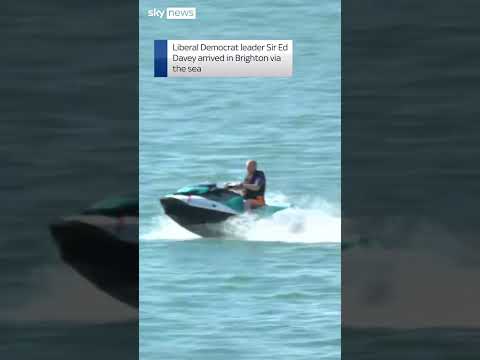 Ed Davey arrives at conference on jet ski