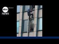 Man dangles from NYC skyscraper in standoff