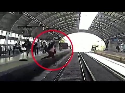 Footage: Man falls in front of oncoming train, rescued Footage: Man falls in front of oncoming train, rescued