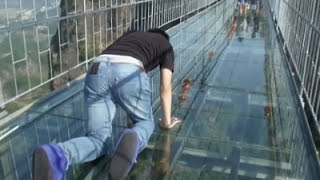 Chinas first glass-bottomed suspension bridge is giving terrified tourists a heart-stopping day out.