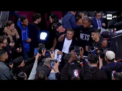 Kevin Durant and Kylian Mbappe share a moment after Nets' win