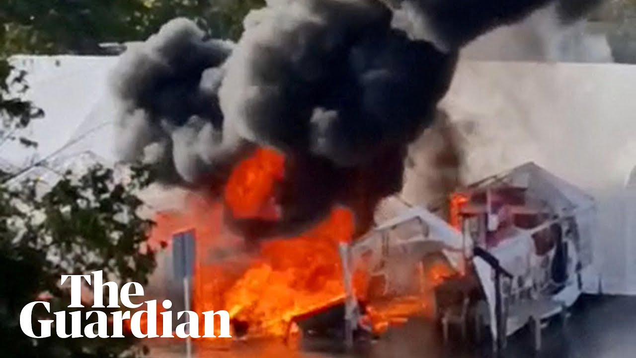 Protesters' tents on fire after shots reportedly fired outside Serbian parliament