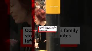 Ozzy Osbourne's family stop to read tributes in Birmingham. #OzzyOsbourne #BBCNews