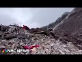 Video shows a huge scar on mountainside after a landslide hits a village in China