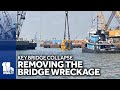 Largest crane, claw removing Key Bridge wreckage