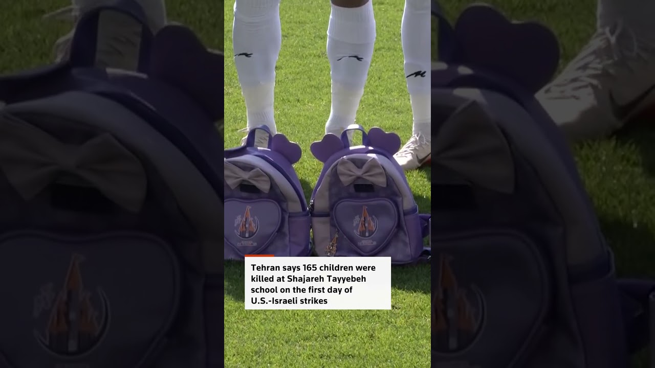 Iranian players hold schoolbags in solidarity with slain girls