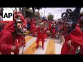 In the streets of Yare, Venezuela dancing red devils give thanks for past miracles