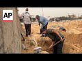 Palestinians in Khan Younis unearth graves in search for loved ones buried in makeshift cemetery