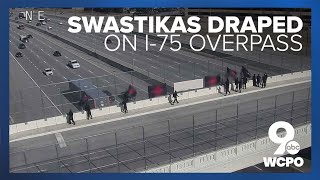 People display swastika-emblazoned flags over I-75 overpass in Cincinnati