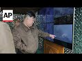 North Korean state media shows Kim Jong Un watching rocket launches